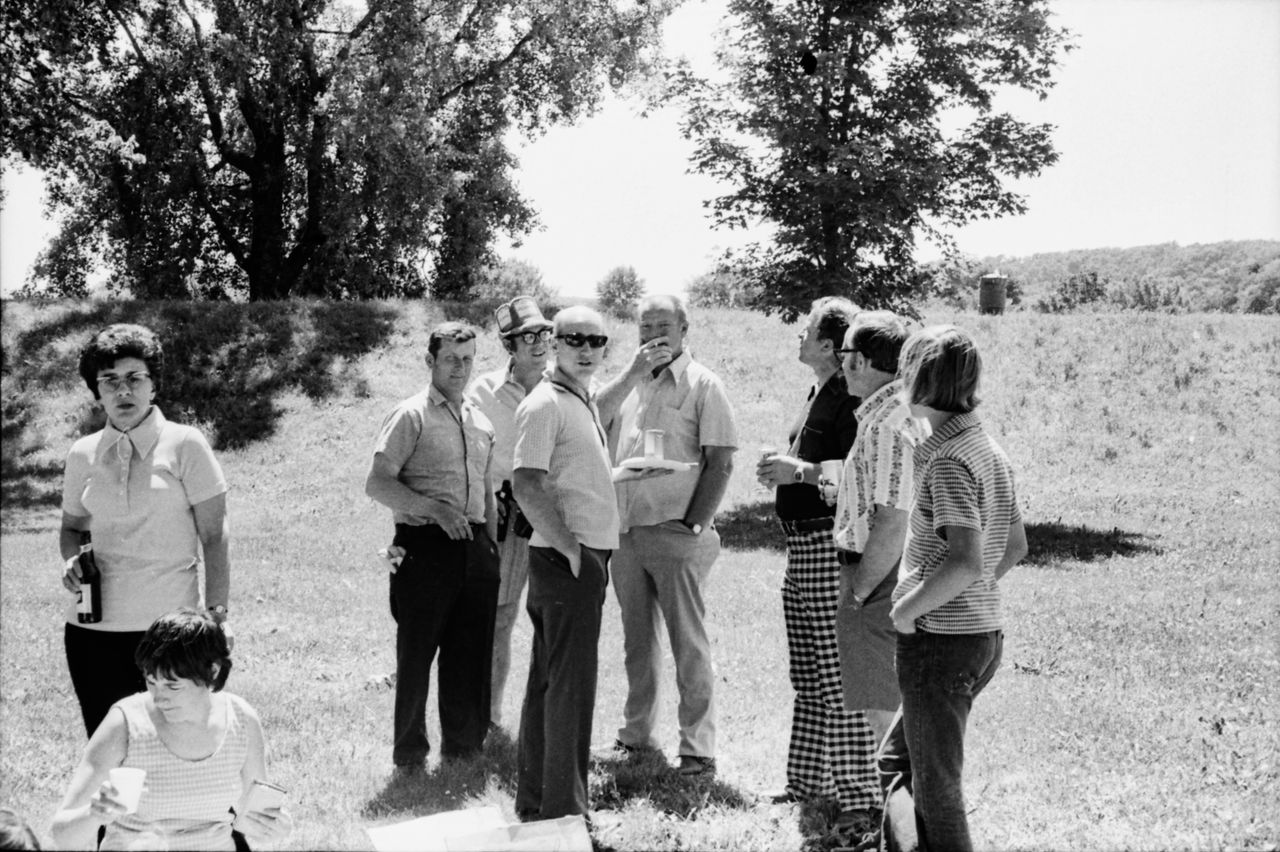 A black and white photo of a group of adults socializing at an outdoor park in Wabasha, Minnesota.
