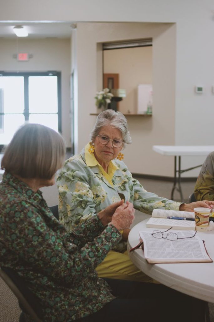 Women engage in thoughtful Bible study at a community church in Brevard, NC.
